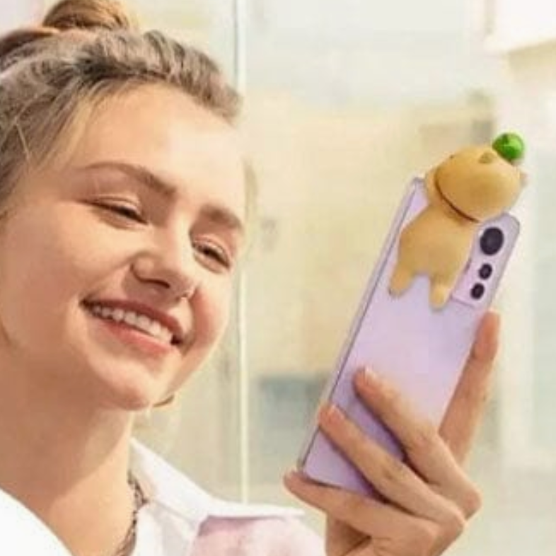 Woman holding a phone with a cute animal-shaped phone holder, surrounded by promotional text for 'Mobile phone decoration'.