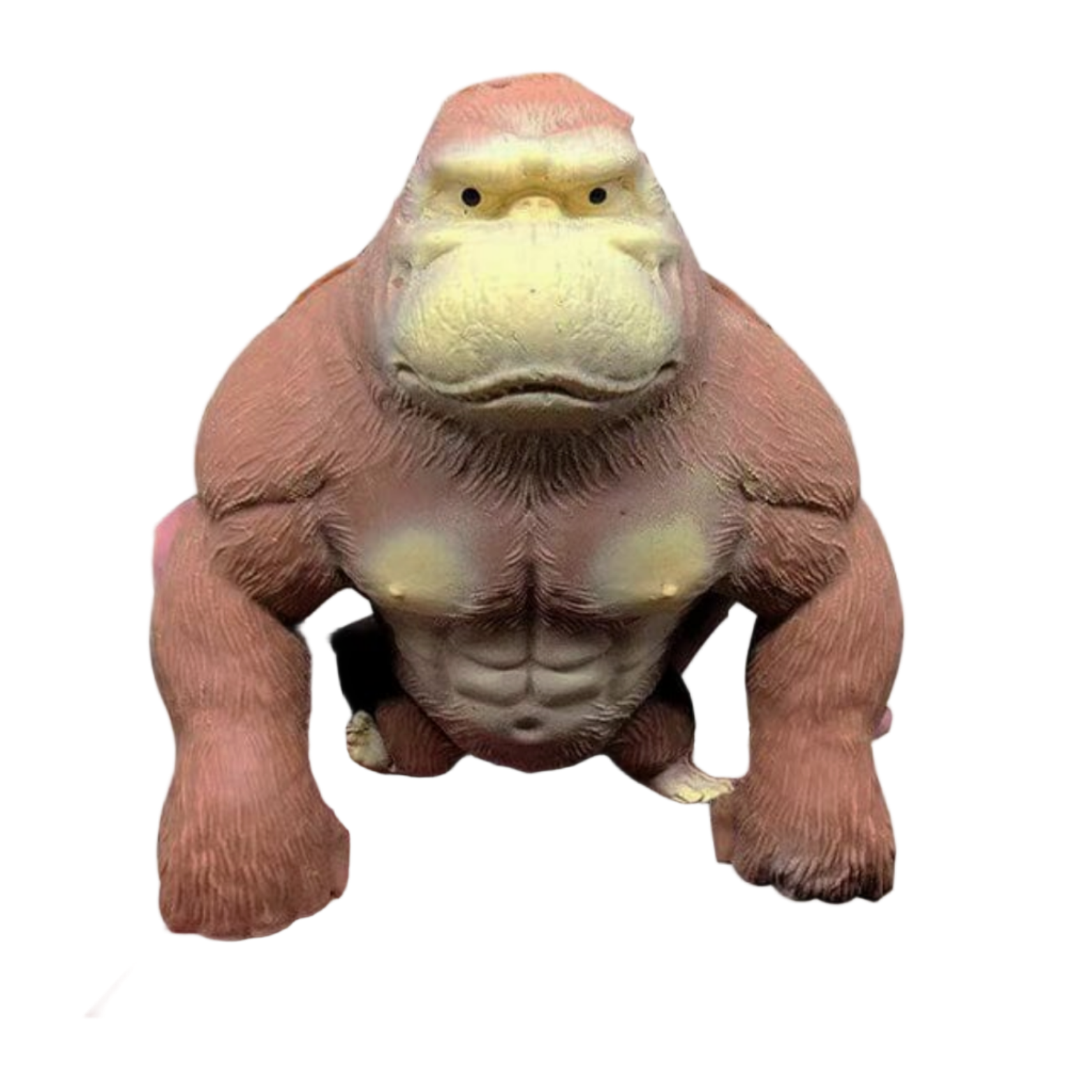 Toy figure of a muscular ape held in a hand against a white background