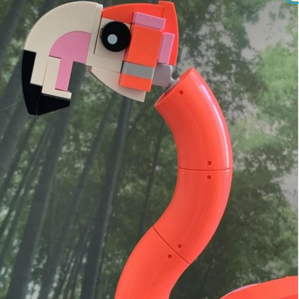 Toy flamingo with a blurred natural background