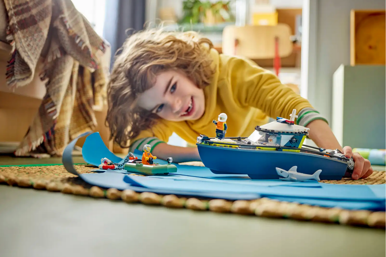 Child playing with a toy boat on a rug