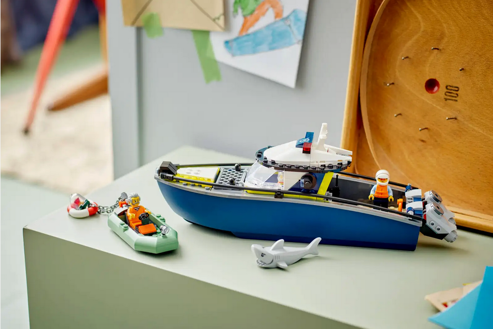 Toy boat set with figures and accessories on a table