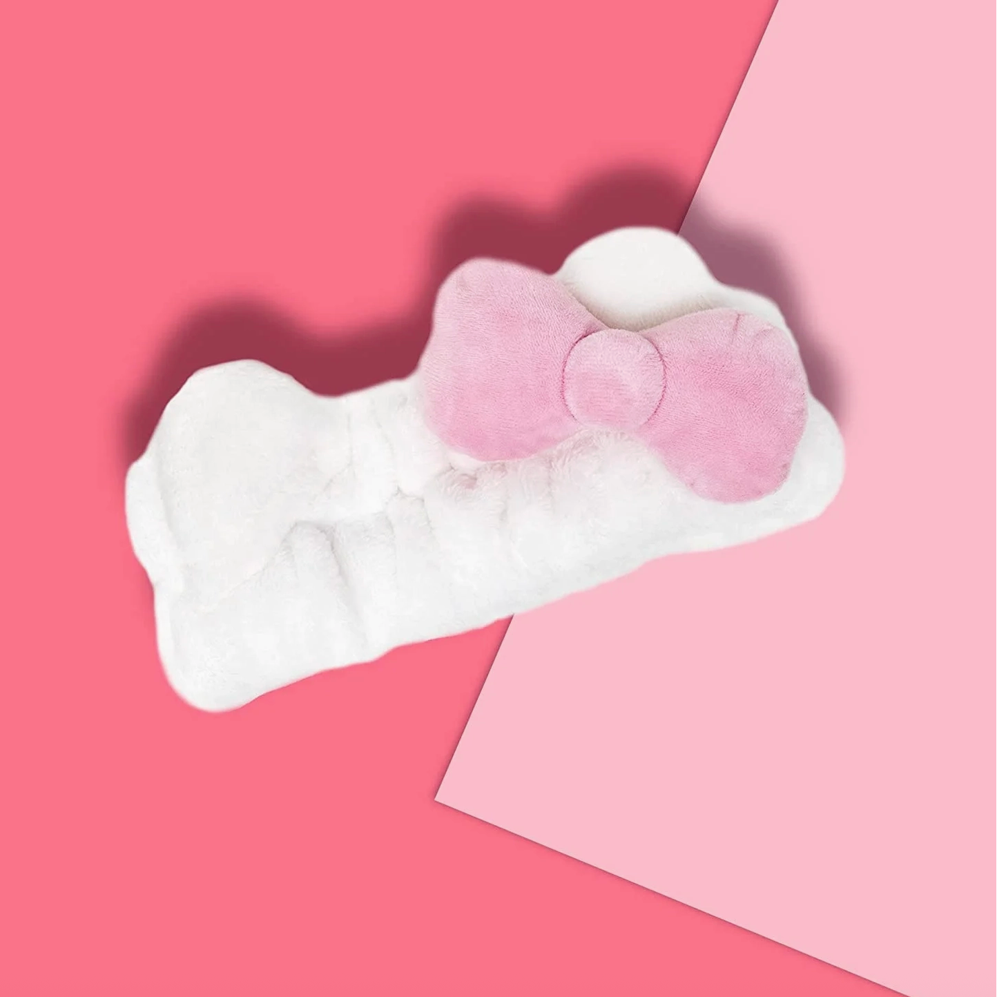 White and pink eye mask on a pink background