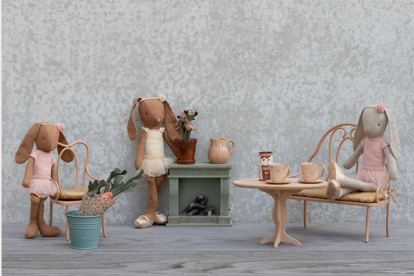 Stuffed animal toys in a room setting with furniture and decor.