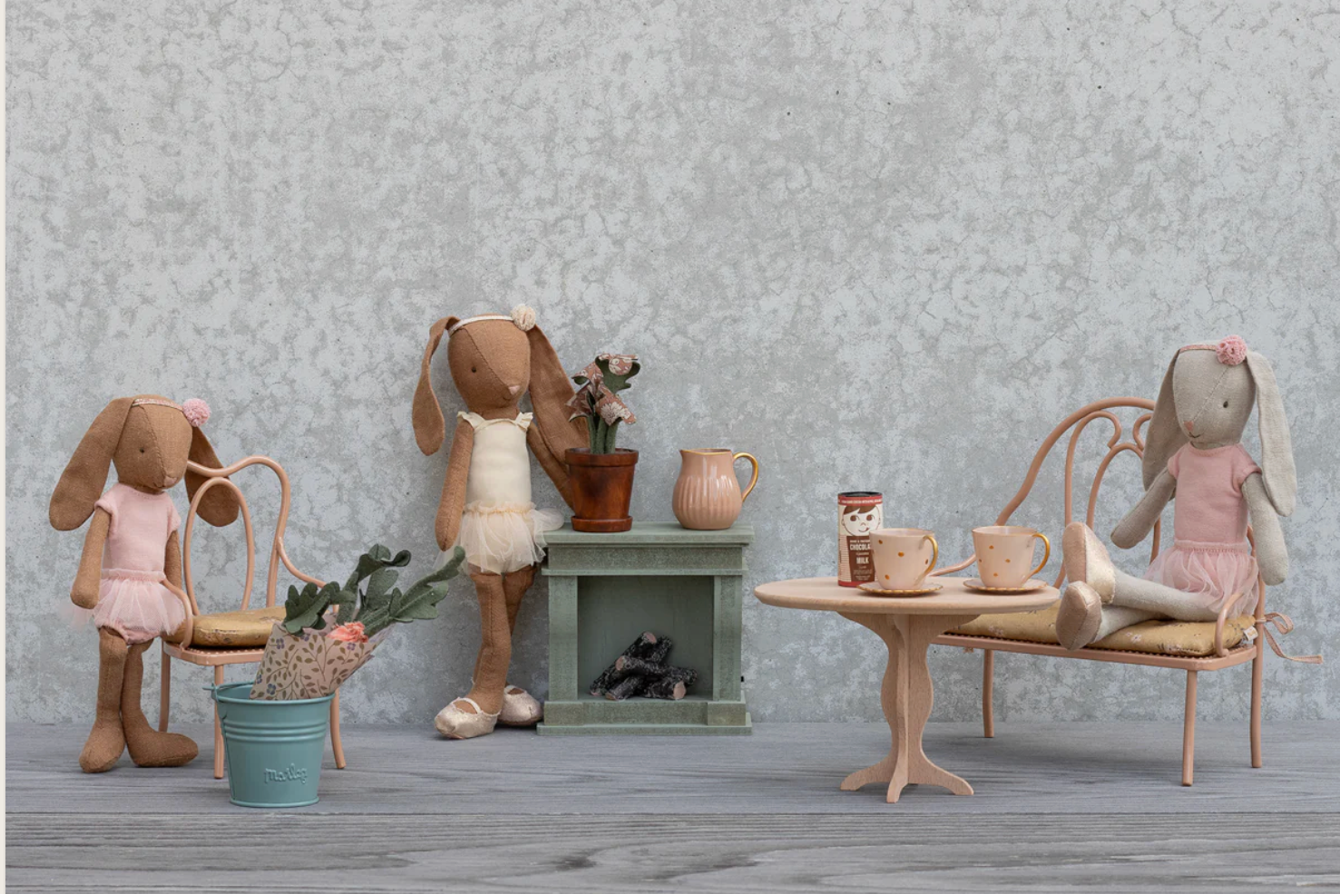Stuffed animal toys in a room setting with furniture and decor.