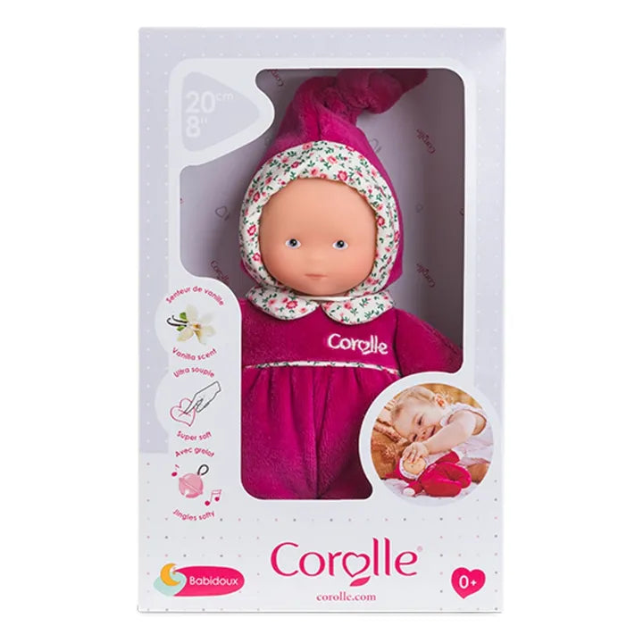 Corolle doll in packaging with pink outfit and floral headband on a white background